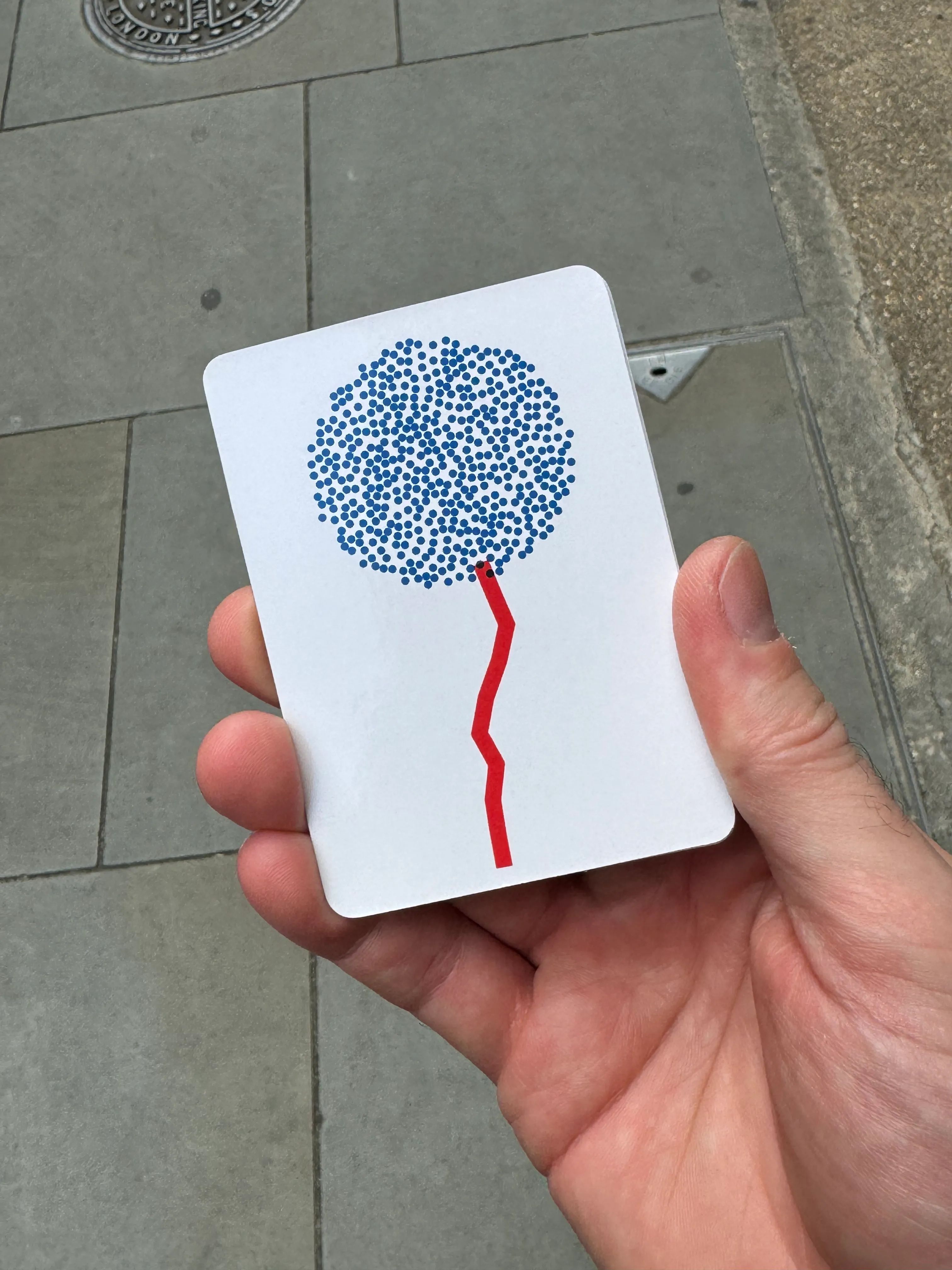 A hand holding an Algodeck card.